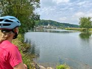 Cyclist by the riverside, gazing at the waters of the Loire