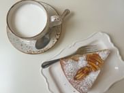 A piece of apple pie and a cappuccino in a cafe in Vicenza.