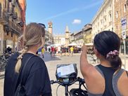 Women cyclists in the old town of Verona