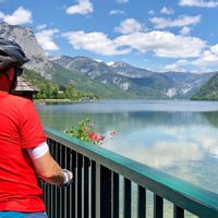 Cyclist enjoying the view of Lake Hallstatt with mountain panorama in the background
