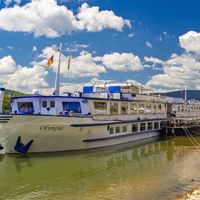 MS Olmpia at a pier on the Rhine River