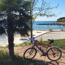 Cycling break on the beach in Porec
