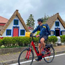Cyclist in front of Portuguese straw huts