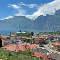 View from Nago of a sea of ​​houses, Lake Garda and the mountains.