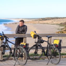 Cyclist enjoys a break on the wooden footbridge