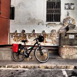 Bicycle in front of an ancient house wall in Agres