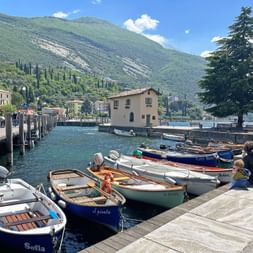 The port of Torbole on Lake Garda with ships on the water.