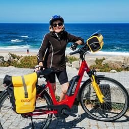 Cyclist with rental bike on the Atlantic coast in Furadouro