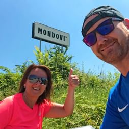 Cyclist in front of the Mondovi town sign