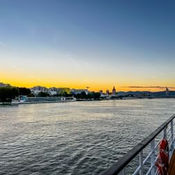 View of the Danube and Vienna from the boat at sunset