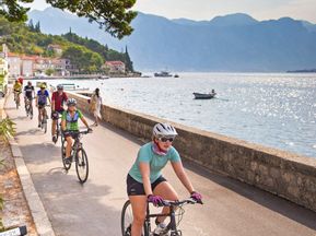 Cyclists on a cycle path in Perast in the Bay of Kotor