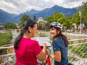 Cyclist with map in Merano