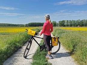 Cyclist taking a break on a country road
