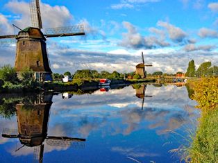 Windmills by a river in the Netherlands