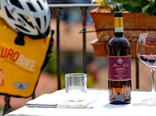 Red wine; Eurobike saddlebag and bike helmet in the background
