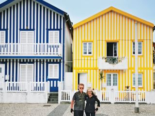 Cyclists in front of Palheiros in Praia da Costa Nova