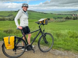Employee Claudia with hire bike in Val d'Orcia