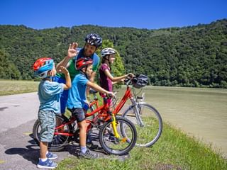 Family by the lake, father gives child high five