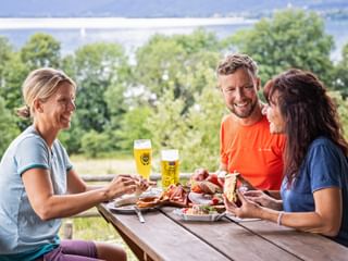 Three people having a snack at Lake Tegernsee in Kaltenbrunn