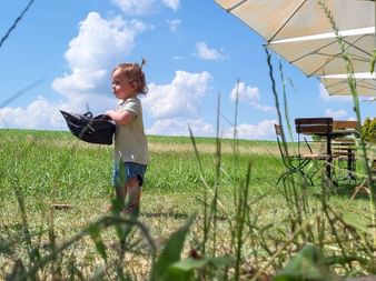 Toddler in the meadow with cycle helmet