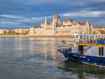River cruise ship MS Prinzessin Katharina on the Danube with the Hungarian Parliament Building in Budapest visible in the background.