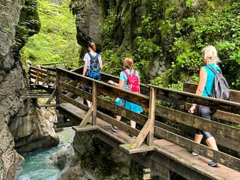 Hikers on a wooden bridge in the Seisenbachklamm gorge