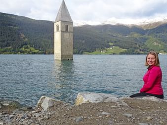 Hannah in front of the sunken church at Lake Resia