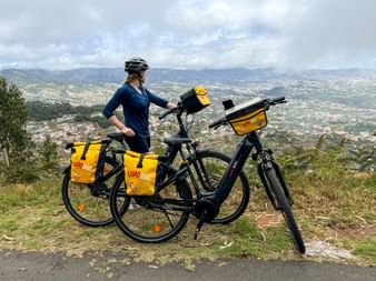 Two bicycles and cyclist looking into the distance