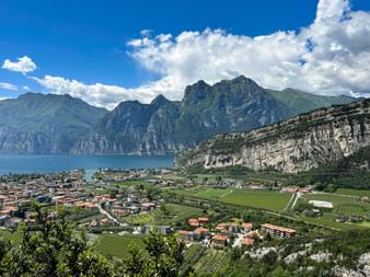 View from Nago of a sea of ​​houses, Lake Garda and the mountains.