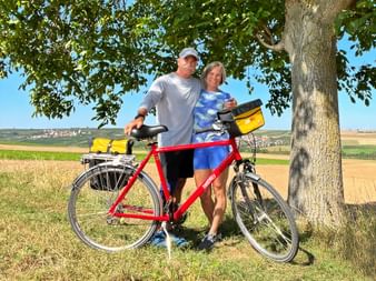 Cyclists stand with their bikes in the landscape