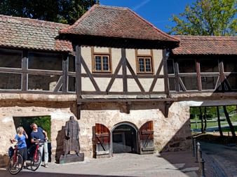 Cyclists in front of frame house in Ansbach