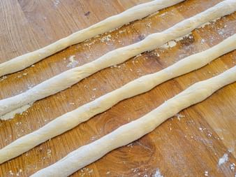 The rolled out dough strands before braiding