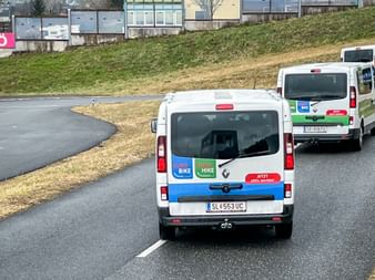 Two white Eurofun vans with Eurobike and Eurohike branding driving on a curved road during a safety training session.