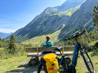 Woman takes a break from cycling on the Formarinweg