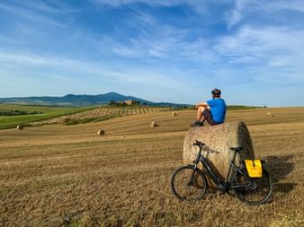 Cyclist resting on hay bales