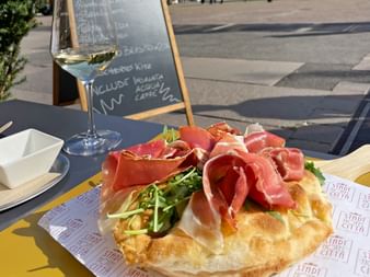 Foccacia with a glass of wine in a restaurant on Piazza Walther in Bolzano