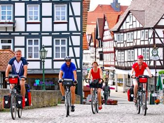 Group of cyclists in the old town centre of Melsungen