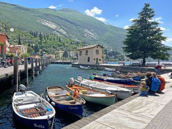The port of Torbole on Lake Garda with ships on the water.