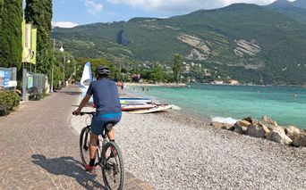 Cyclists on the lake shore in Riva del Garda