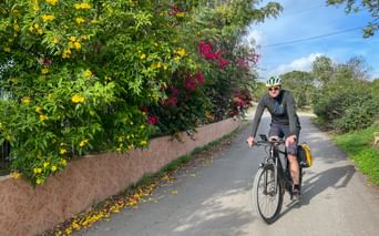 Cyclists surrounded by flowering bushes