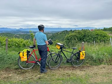 Man with two bicycles on Monte Berici with a beautiful view.