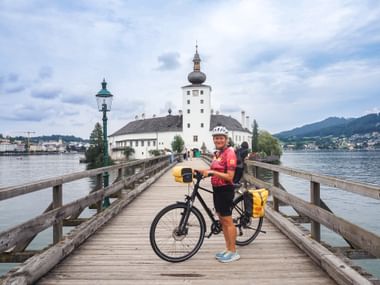 Cyclist outside Seeschloss Ort, Gmunden