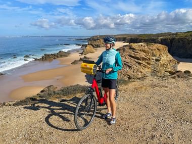Cyclist on the beach near Sines