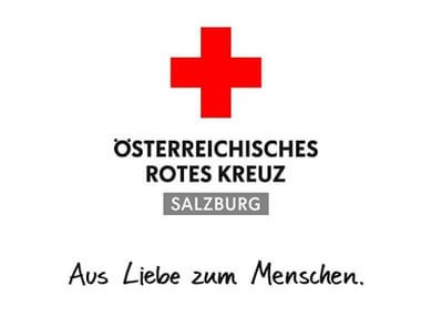 Logo of Austrian Red Cross Salzburg with red cross symbol and German text 'Aus Liebe zum Menschen' (Out of love for people).