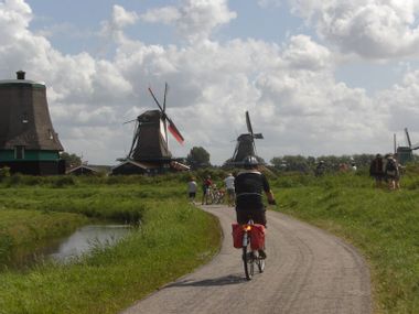 Cyclists at windmills in Holland
