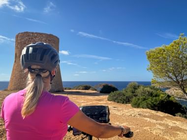Cyclist gazes into the distance in Torre de Cala Pi