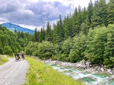 Cyclists stop at the Krimmler Ache river