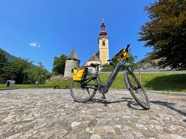 Eurobike rental bike near the fortified church in Tarvisio
