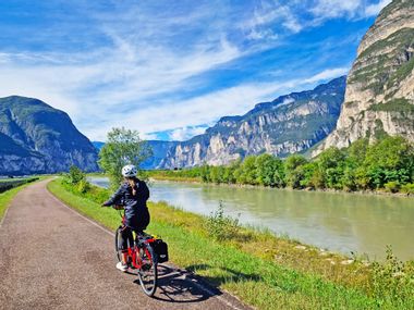 Bike path along the Adige river with cyclist