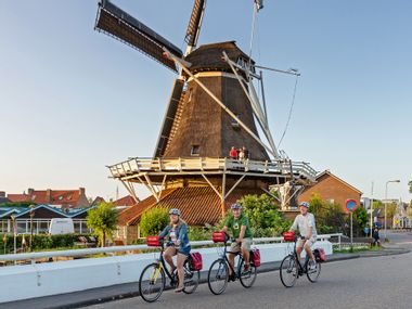 Cycling group in front of a windmill in Meppel